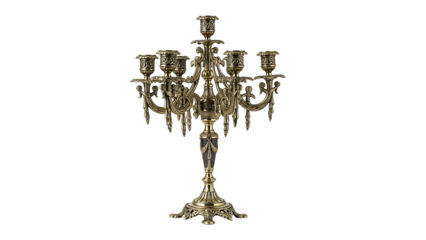 Ornate multi-arm metal candlestick fixture stands against a solid dark background