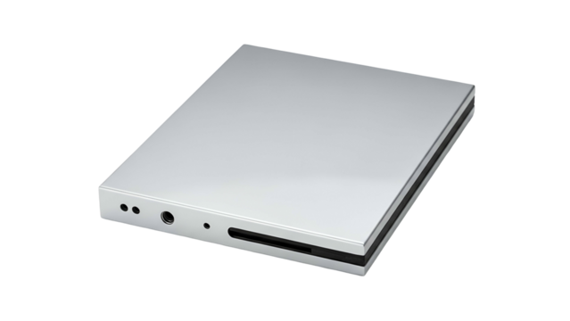 Slim silver electronic device with input output ports rests against a black background