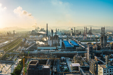 Aerial shot of an oil refinery and chemical plant with smoking chimneys in a large industrial area
