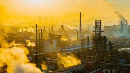Aerial shot of an oil refinery and chemical plant with smoking chimneys in a large industrial area...