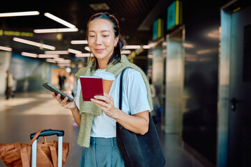 Happy woman checking travel details on smartphone, holding passport and coffee. Modern technology assisting travel and journey © we.bond.creations