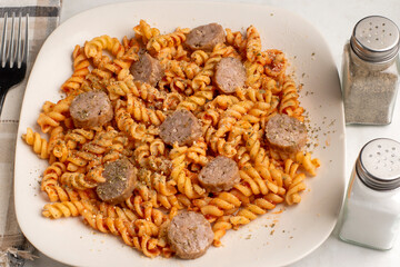Fototapeta premium rotini with sweet italian sausage and seasoning