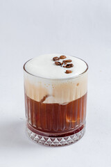 This creamy coffee drink features frothy milk and roasted beans, presenting a delightful treat
