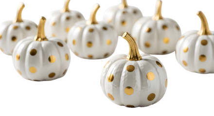 A collection of decorative white pumpkins with gold polka dots isolated on transparent background