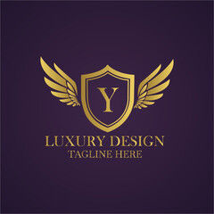 Elegant golden logo design with letter y on shield and wings for luxury brand identity concept