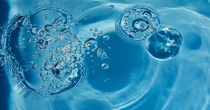 Bubbles Rising in Clear Blue Water Creating Ripples and Patterns Under Natural Light