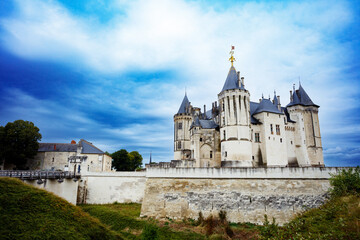 Majestic stone fortress Saumur with towers against a blue sky