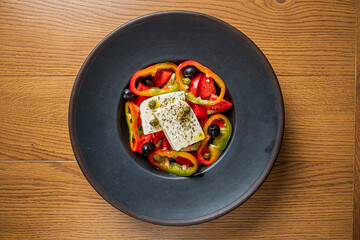 Fresh peppers and olives surround creamy feta, creating a vibrant dish perfect for any meal