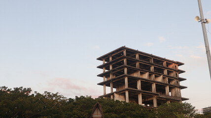 high rise building under construction with a clear sky background