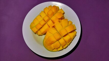 Fresh ripe mango slices served on a plate 