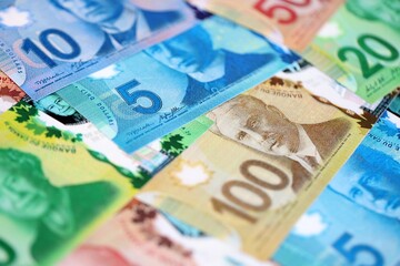 Canadian Dollar currency money bills. CAD currency banknotes in big stack with different denomination close up