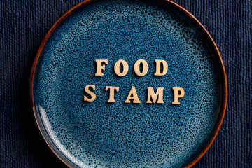 The inscription on the blue plate about food stamp, closeup. The Supplemental Nutrition Assistance Program, known as the Food Stamp Program, is a United States federal government program