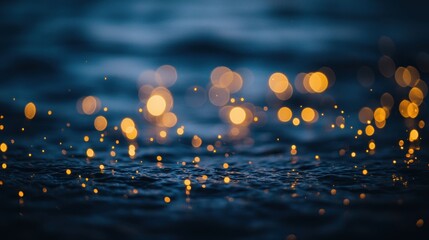 Warm golden bokeh lights sparkle on dark rippling water surface