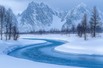 Winding blue river through snowy winter landscape, jagged mountains