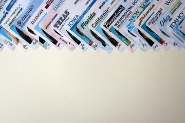 Big amount of driving licenses from various USA states. Stack of driving license specimen cards