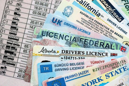 Driving licenses from different countries and American states. Concept of obtaining driving permit