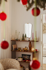 Stylish holiday interior with Christmas ornaments and glowing lights. Cozy festive mood with natural decor and warm tones.