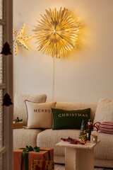 Cozy living room with Christmas decorations, glowing star lights, and festive pillows. Warm holiday...