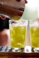 Making atmospheric rustic cocktails in faceted glasses
