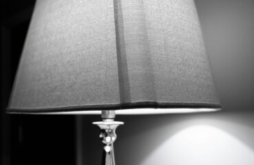 A close-up of a fabric lampshade with a soft glow illuminating the surrounding area