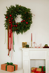 Minimalist Christmas interior with a green wreath, red ribbons, and festive gifts. Warm and elegant holiday styling.