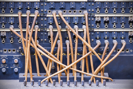 Vintage telecommunications telephone switchboard with connected wires - Powered by Adobe