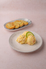 greek spicy cheese dip, tyrokafteri with garlic bread on the side, and a slice of cucumber
