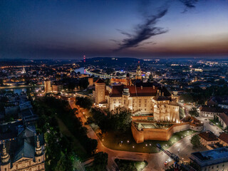 Aerial evening view of Wawel Castle in Krak&oacute;w, Poland, with illuminated walls and Vistula River