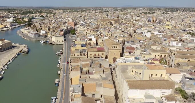 Aerial view of the Mazaro River, which bisects the city of Mazara del Vallo, in the province of Trapani, Sicily, Italy. The town's historic center is located on the banks of the river.