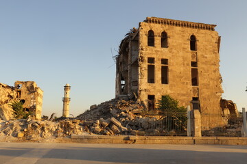 Fototapeta premium War torn Aleppo, Syria. Destroyed buildings after heavy airstrikes and fierce frontline battles, showing the brutality of war, human suffering, and the urgent need for reconstruction and peace.