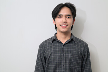 Portrait of handsome Young Asian Thai man smiling against white background