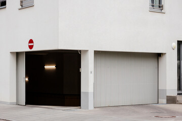 Garage Door Gate of Residential Apartment Basement Parking. Entrance to Underground Parking Lot of Corner Building.