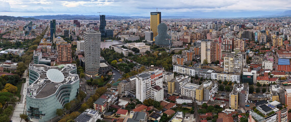 Panoramic aerial view of Tirana city center, Albania, showing Skanderbeg Square, modern skyline, and autumn urban landscape.