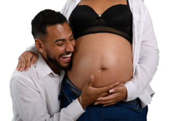 Happy dad listens to his pregnant partner's belly.