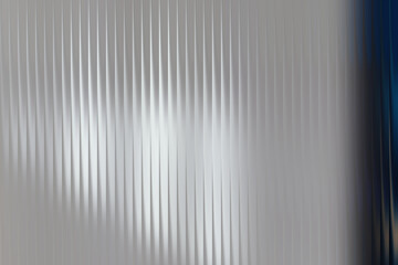 Abstract metallic background with vertical lines and blue edge 