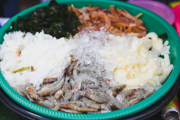 Fresh shrimp and ingredients for spicy Thai salad on ice.