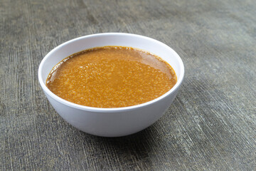 kelapa gongseng,  grated coconut that is roasted until dry and fragrant with a brownish color, often used as a seasoning in traditional Indonesian dishes such as rendang, gulai, and other dishes