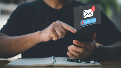 Businessman touching new message notification icon on virtual screen,email alert, online messaging system, representing digital communication, instant response, and business connectivity.
