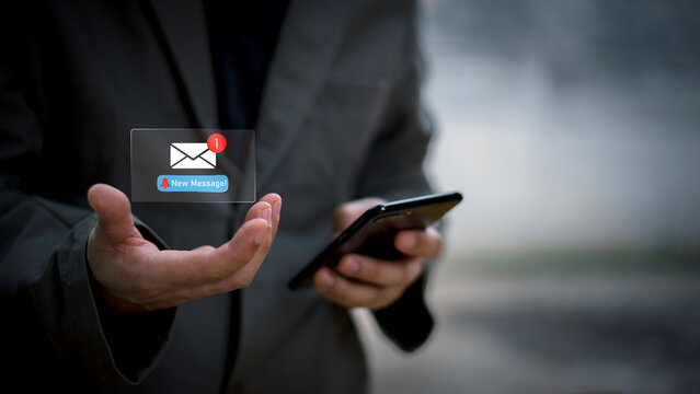 Businessman touching new message notification icon on virtual screen,email alert, online messaging system, representing digital communication, instant response, and business connectivity.