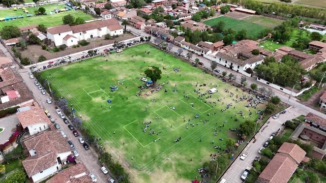 Authentic Peruvian scene: Locals gather for a soccer match in the unique green plaza of Yucay, Sacred Valley