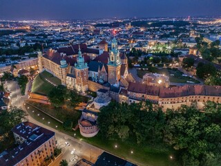 Aerial evening view of Wawel Castle in Krak&oacute;w (Cracow), Poland, with illuminated walls and Vistula River