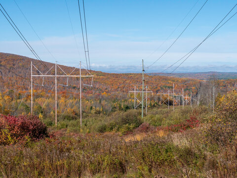 Wide view of transmission lines through rural Maine in the fall.