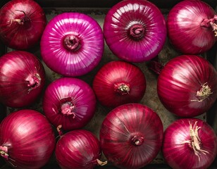 Top view of red onions arranged closely on a tray, highlighting rich color, natural texture, and fresh, rustic food presentation.