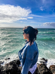 Young woman with sunglasses enjoying a sunny day on Fuerteventura beach