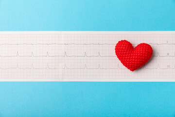 Medical stethoscope, red heart, and cardiogram on a color background. ECG, Heart wave, heart attack, cardiogram report. Cardiogram pulse trace and heart concept. Healthcare.Space for text