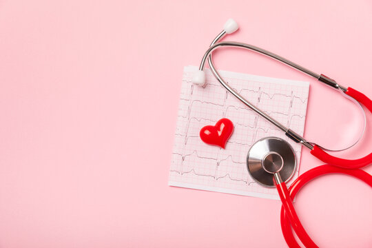 Medical stethoscope, red heart, and cardiogram on a color background. ECG, Heart wave, heart attack, cardiogram report. Cardiogram pulse trace and heart concept. Healthcare.Space for text