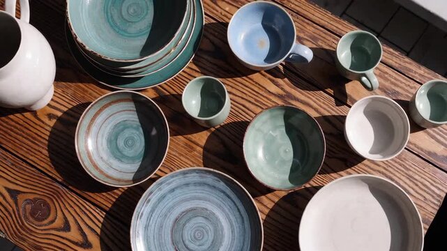 Elegant ceramic dishware display shows artistic arrangement and sunlit patterns