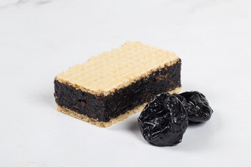 Fitness food.  Waffles with prunes. Close-up. White bacckground	