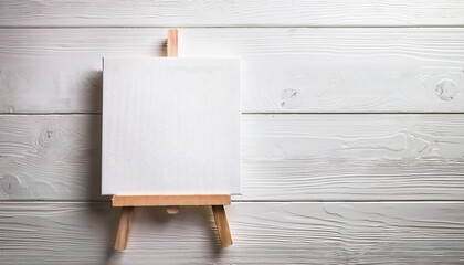 Blank White Canvas on Wooden Easel against White Rustic Wooden Background Ready for Artwork or Message