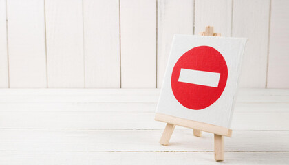 Red No Entry Symbol on White Canvas Displayed on Small Wooden Easel